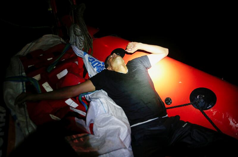 A migrant reacts after being pulled out of the sea on to a rigid-hulled inflatable boat sent by the ‘Sea-Watch 3’.