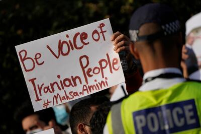 Demonstrators hold placards outside the Iranian embassy in London. AP