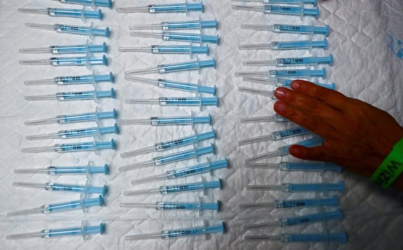 Syringes are prepared to administer the AstraZeneca vaccine at a new mass vaccination centre in WiZink sports arena in Madrid, Spain. Reuters