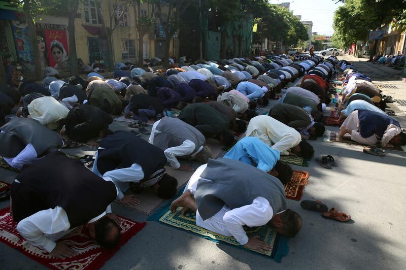 Men offer Eid Al Fitr prayers outside a mosque in Kabul. AP