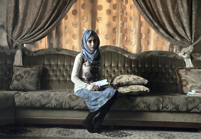 Hadeel Ziad clutches a copy of her novel in her family home in the Mosul Jadida neighbourhood.
Photo: Florian Neuhof