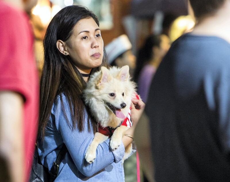 ABU DHABI, UNITED ARAB EMIRATES, 28 OCTOBER 2018 - Pet owner with her dog at the inaugural of Yas Pet Together event at Yas Du Arena, Abu Dhabi.  Leslie Pableo for The National for Evelyn Lau's story