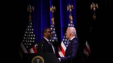 US President Joe Biden speaks with president and chief executive of the NAACP Derrick Johnson at the National Museum of African American History and Culture in Washington. Reuters