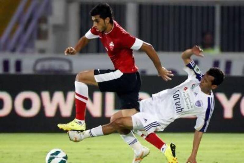 Al Ahli’s Majed Hassan is tackled by Al Ain’s Mohamed Abdulrahman. Games between the rivals last season were intense.