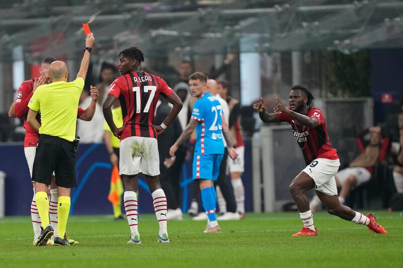 AC Milan's Franck Kessie, right, is shown a red card. AP