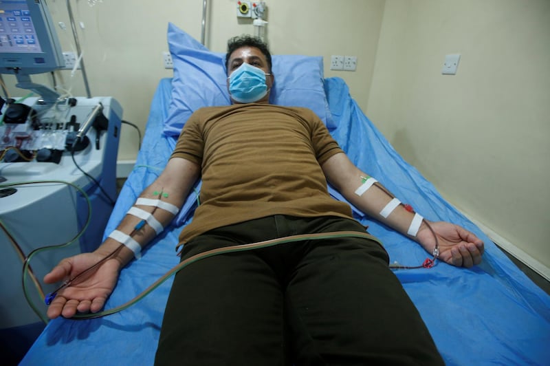 A man who has recovered from the coronavirus wears a protective face mask as he donates his blood plasma to help critically ill patients at Basra Teaching Hospital in Basra, Iraq. Reuters