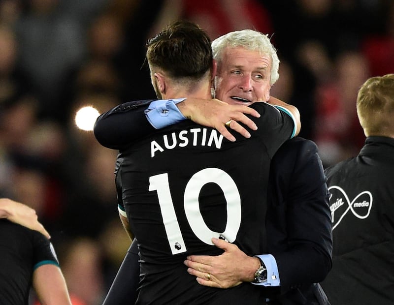 Soccer Football - Premier League - Swansea City v Southampton - Liberty Stadium, Swansea, Britain - May 8, 2018   Southampton manager Mark Hughes and Charlie Austin celebrate after the match     REUTERS/Rebecca Naden    EDITORIAL USE ONLY. No use with unauthorized audio, video, data, fixture lists, club/league logos or "live" services. Online in-match use limited to 75 images, no video emulation. No use in betting, games or single club/league/player publications.  Please contact your account representative for further details.