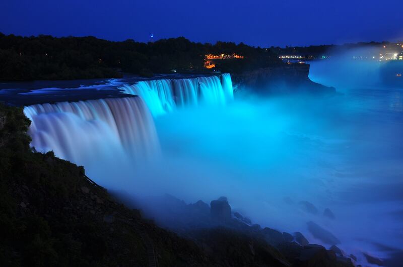 NIAGARA FALLS, NY - JULY 22: Visitors to Niagara Falls receive notice of the sex of the royal baby indicated by the blue light illuminating the falls in Niagara Falls, New York. The Royal couple,The Duke and Duchess of Cambridge, had a baby boy who was born at 16.24 BST and weighed 8 pounds, 6 ounces. The child, who is now third in line to the throne, has yet to be named.   John Normile/Getty Images/AFP== FOR NEWSPAPERS, INTERNET, TELCOS & TELEVISION USE ONLY ==
 *** Local Caption ***  598151-01-09.jpg