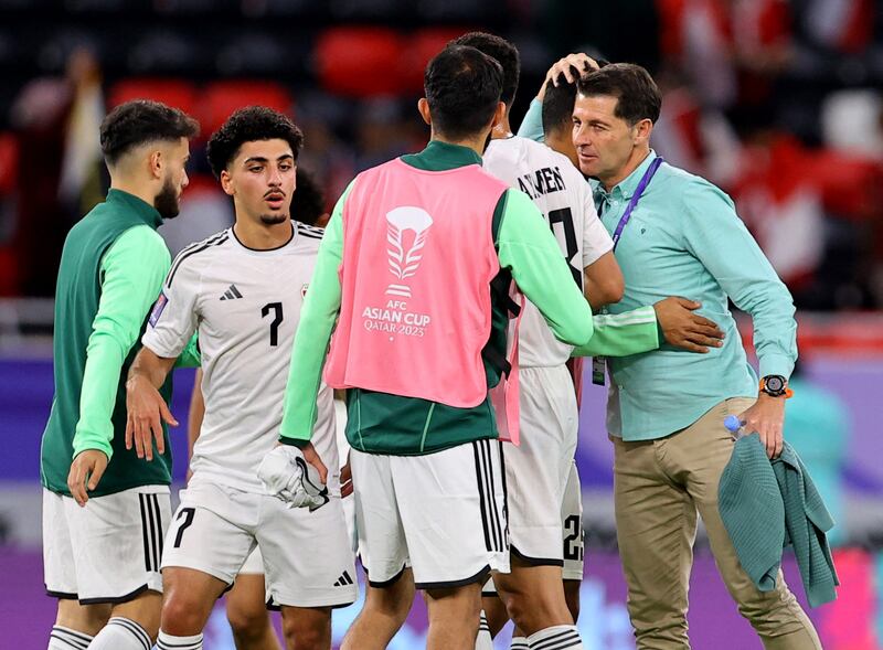 Iraq coach Jesus Casas, right, celebrates with his players after their Asian Cup Group D victory over Indonesia. Reuters