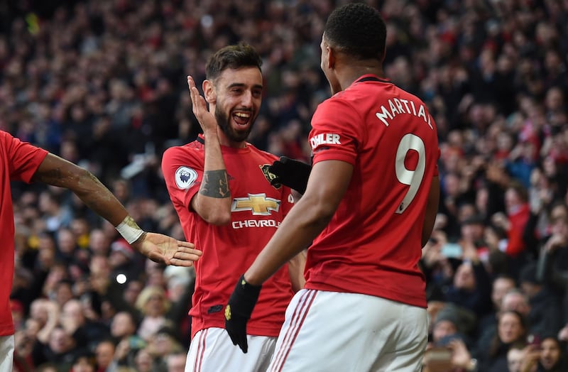 Anthony Martial celebrates with teammate Bruno Fernandes, who provided the Frenchman with the assist for Manchester United's opener in their game against Manchester City, the last in the Premier League before the coronavirus lockdown. United won 2-0. EPA