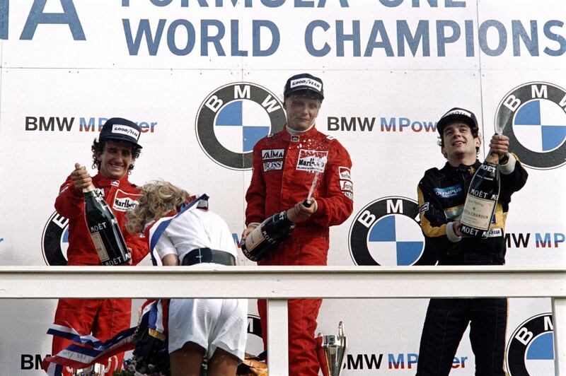 (FILES) In this file photo taken on August 25, 1985 World champion Niki Lauda (C) of Austria celebrates his victory on the podium after winning the Dutch Formula One Grand Prix in Zandvoort, with his McLaren teammate French Formula One driver Alain Prost (L), second, and Brazilian Lotus Ayrton Senna (R), third - Legendary Formula One driver Niki Lauda has died at the age of 70, his family said in a statement released to Austrian media on May 21, 2019. (Photo by Dominique FAGET / AFP)