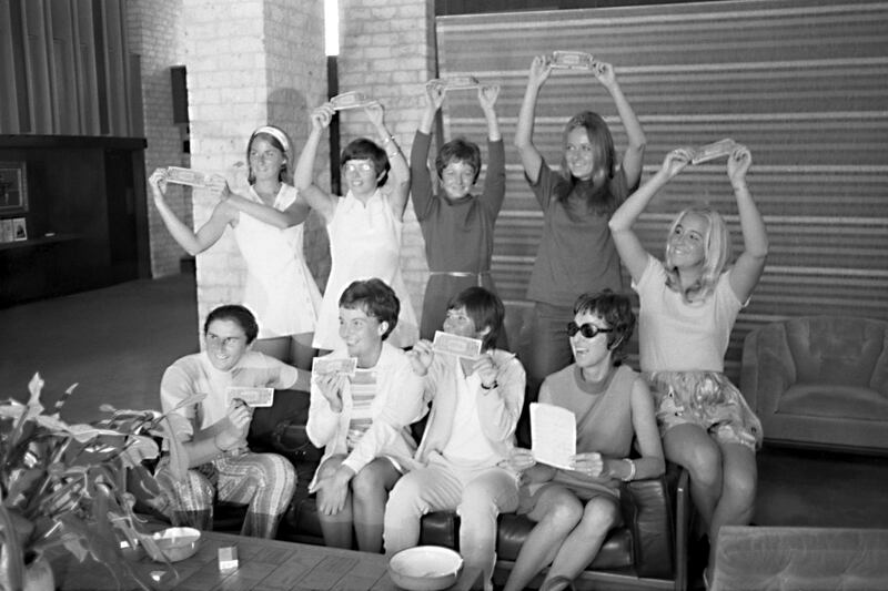 In this Sept. 23, 1970, photo provided the Houston Library, tennis players hold up $1 bills after signing a contract with World Tennis magazine publisher Gladys Heldman to turn pro and start the Virginia Slims tennis circuit. From left standing are: Valerie Ziegenfuss, Billie Jean King, Nancy Richey and Peaches Bartkowicz. From left seated are: Judy Tegart Dalton, Kerry Melville Reid, Rosie Casals, Gladys Heldman and Kristy Pigeon. Gladys Heldman replaced her daughter, Julie Heldman, who was injured and unable to pose for the 1970 photo.  Itâ€™s the 50th anniversary of Billie Jean King and eight other women breaking away from the tennis establishment in 1970 and signing a $1 contract to form the Virginia Slims circuit. That led to the WTA Tour, which offers millions in prize money. (Bela Ugrin/Courtesy Houston Library via AP)