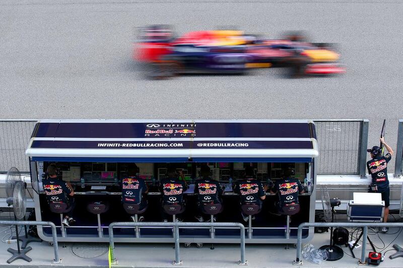 Red Bull driver Daniel Ricciardo passes members of his team on the pit perch. Mark Thompson / Getty Images