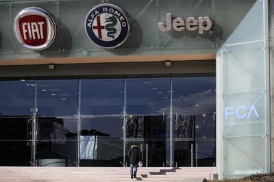 (FILES) In this file photo taken on January 13, 2017 a man walks up stairs as the logos of automobile companies (LtoR) Fiat, Alfa Romeo and Jeep are pictured at the entrance to the Fiat Chrysler Automobiles (FCA) at the Fiat Mirafiori car plant in Turin, northern Italy.  

 Fiat Chrysler shares took a hit on the Milan and New York stock exchanges on July 23, 2018 after the auto giant's boss of 14 years Sergio Marchionne suffered life-threatening health problems. At the open in Milan, sister companies Fiat Chrysler Automobiles (FCA), Ferrari and CNH Industrial saw their shares fall over four percent each, although they recovered some ground later in the day. The three groups are controlled by the Agnelli family.
 / AFP / MARCO BERTORELLO
