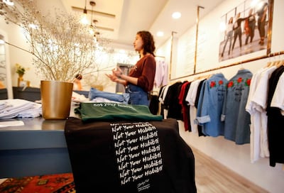 Palestinian fashion designer Yasmeen Mjalli speaks while standing in her clothing shop where her label collection "BabyFist" carrying anti-sexual harassment slogans is showcased, in Ramallah in the occupied West Bank on December 19, 2018. It's only three words on a T-shirt or embroidered on a denim jacket, but they carry a powerful message: "Not you habibti (darling)." "BabyFist" label founder Yasmeen Mjalli, 22, sees the clothes helping to empower Palestinian women facing unwelcome male attention in public, placing on the fabrics of muted colours and on canvas bags messages in English and Arabic inside drawings of flowers and other designs. / AFP / ABBAS MOMANI
