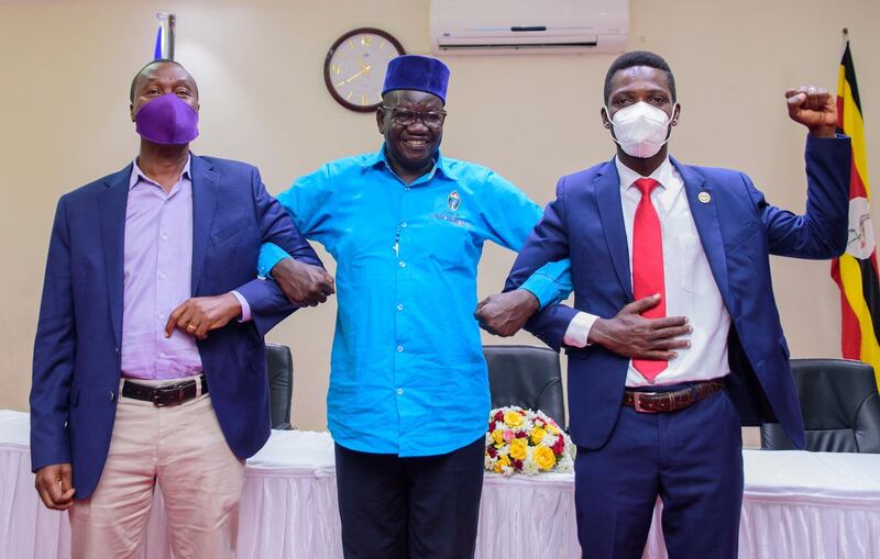 Ugandan presidential candidate Bobi Wine, right, poses for a photograph with other opposition leaders Patrick Oboi Amuriat, centre, and Mugisha Muntu during a press conference in Kampala on January 12, 2021. EPA