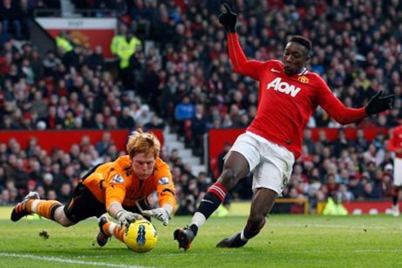 Bolton Wanderers' Adam Bogdan (L) makes a save against Manchester United's Danny Welbeck during their English Premier League soccer match at Old Trafford in Manchester, northern England, January 14, 2012.   REUTERS/Darren Staples   (BRITAIN - Tags: SPORT SOCCER) FOR EDITORIAL USE ONLY. NOT FOR SALE FOR MARKETING OR ADVERTISING CAMPAIGNS. NO USE WITH UNAUTHORIZED AUDIO, VIDEO, DATA, FIXTURE LISTS, CLUB/LEAGUE LOGOS OR "LIVE" SERVICES. ONLINE IN-MATCH USE LIMITED TO 45 IMAGES, NO VIDEO EMULATION. NO USE IN BETTING, GAMES OR SINGLE CLUB/LEAGUE/PLAYER PUBLICATIONS