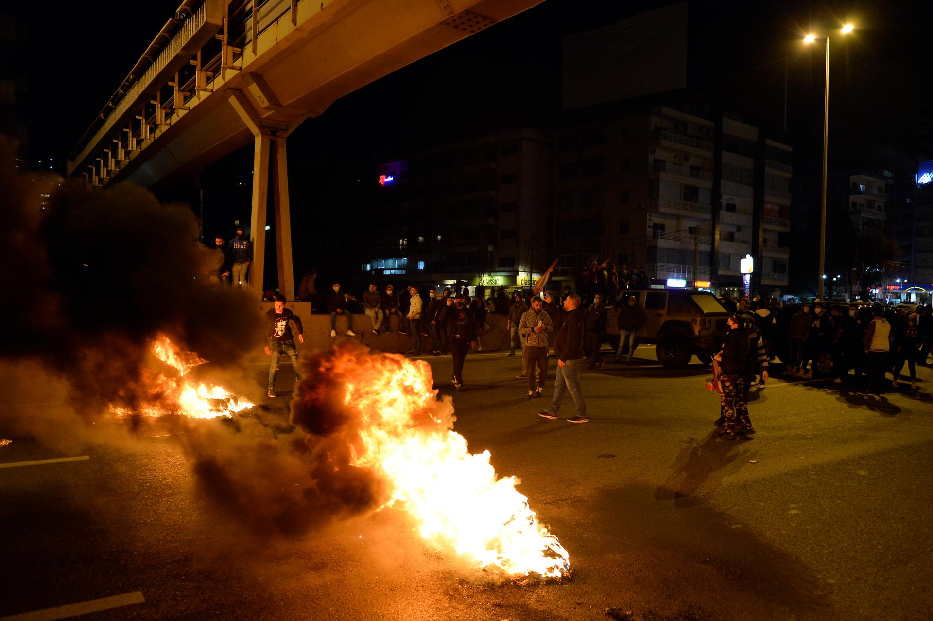 Anti-government protesters burn tires to block a main road during a protest against the power cuts, the high cost of living, the low purchasing power of the Lebanese pound, in Jal El Dib area north Beirut. EPA