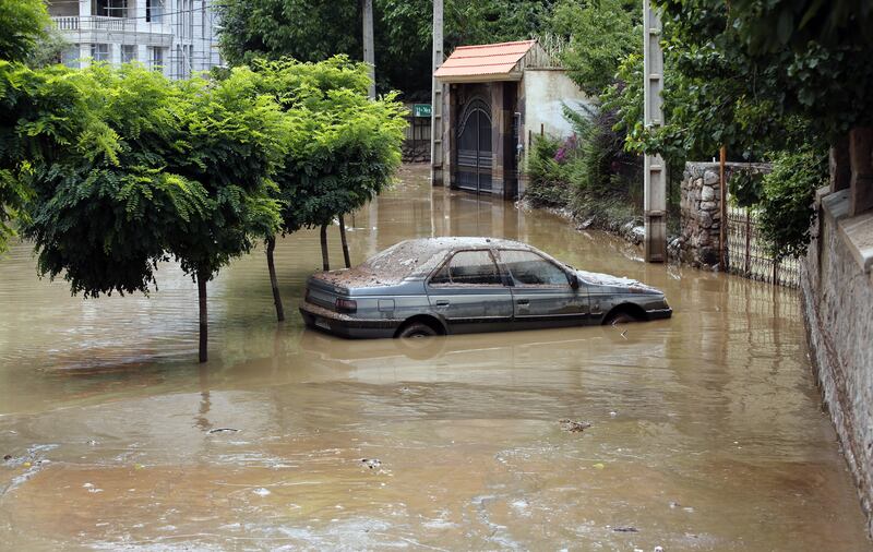 A submerged car at the site of a flash flood in Zayegan village, north of Tehran, in August 2022. EPA