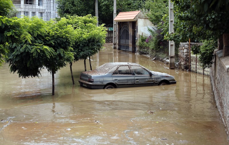 A car submerged by a flash flood in Zayegan village, in the Iranian city of Fasham, north of Tehran. EPA