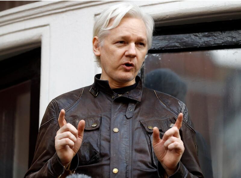 FILE - In this May 19, 2017 file photo, WikiLeaks founder Julian Assange gestures to supporters outside the Ecuadorian embassy in London, where he has been in self imposed exile since 2012. A British judge on Tuesday Feb. 13, 20-18 is scheduled to quash or uphold an arrest warrant for WikiLeaks founder Julian Assange, who has spent more than five years inside Ecuador's London embassy. Assange's lawyers argue that it's no longer in the public interest to arrest him for jumping bail in 2012. Assange was wanted in Sweden for a rape investigation when he sought protection in the Ecuadorean embassy. Swedish prosecutors dropped the case last year, but the British warrant still stands. (AP Photo/Frank Augstein, FILE)