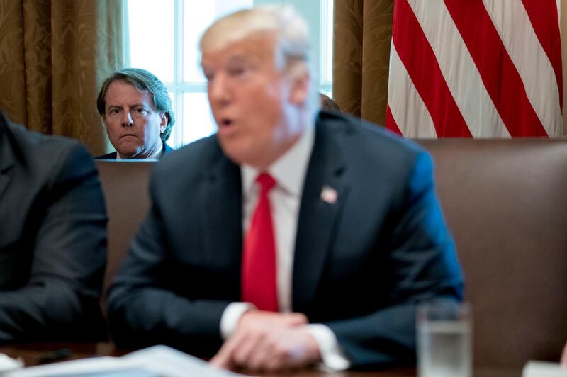 FILE- In this Aug. 16, 2018, file photo White House counsel Donald McGahn, left, listens as President Donald Trump speaks during a cabinet meeting in the Cabinet Room of the White House in Washington. Trump insisted Sunday, Aug. 19, that McGahn isn't "a John Dean type 'RAT,'" making reference to the Watergate-era White House attorney who turned on Richard Nixon. (AP Photo/Andrew Harnik, File)