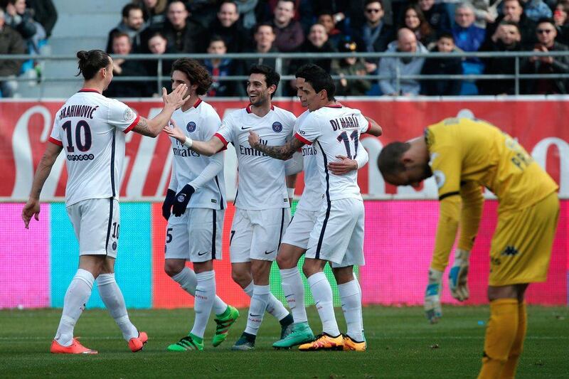 PSG's Javier Pastore, center, celebrates with teammate after scoring, as Troyes' goalkeeper Matthieu Dreyer, right, reacts during their Ligue 1 match in Troyes, France, Sunday, March 13, 2016. (AP Photo/Thibault Camus)