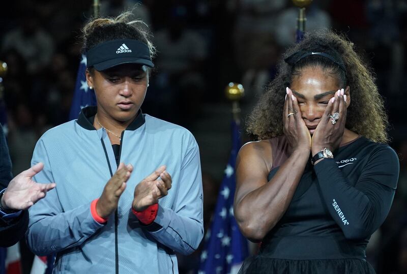 TOPSHOT - US Open Womens Single champion Naomi Osaka of Japan (L) with Serena Williams of the US during their Women's Singles Finals match at the 2018 US Open at the USTA Billie Jean King National Tennis Center in New York on September 8, 2018. (Photo by TIMOTHY A. CLARY / AFP)