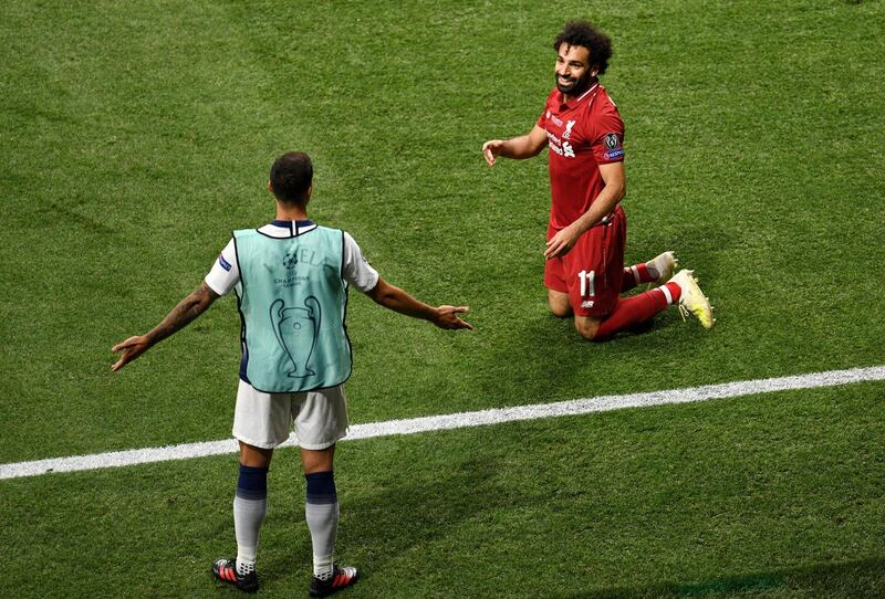 Mohamed Salah of Liverpool and substitute Erik Lamela of Tottenham Hotspur share a joke during the UEFA Champions League Final. Getty