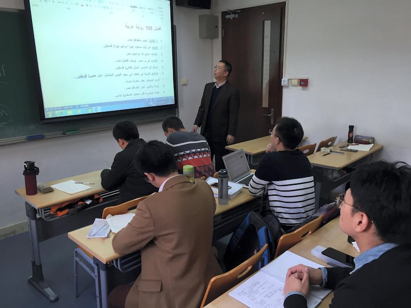 Dr. Lin Feng Min, Director of the Arabic Department of Peking University, teaching students Arabic. (Lu-Hai Liang forThe National)