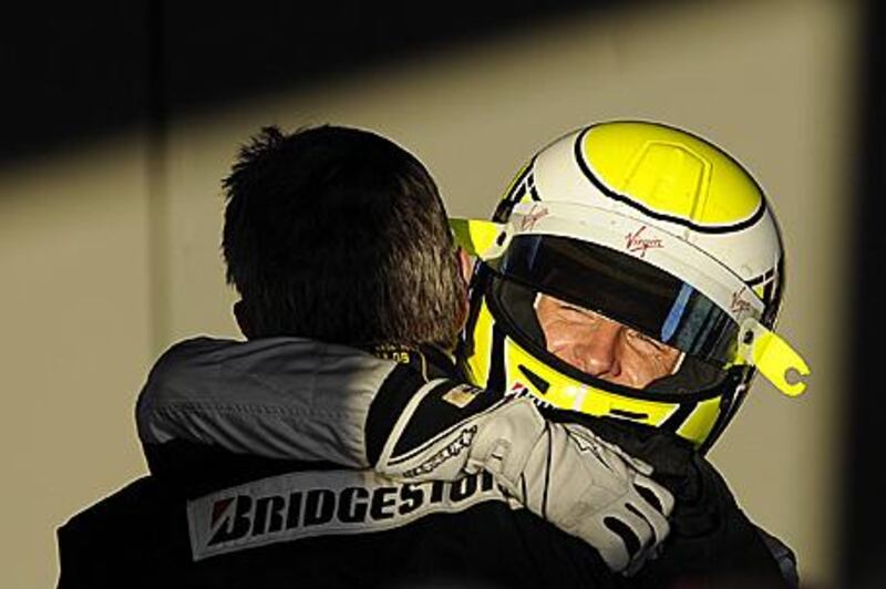 Brawn's Jenson Button hugs his team boss, Ross Brawn, after winning the Australian Grand Prix last year en route to a drivers' title.