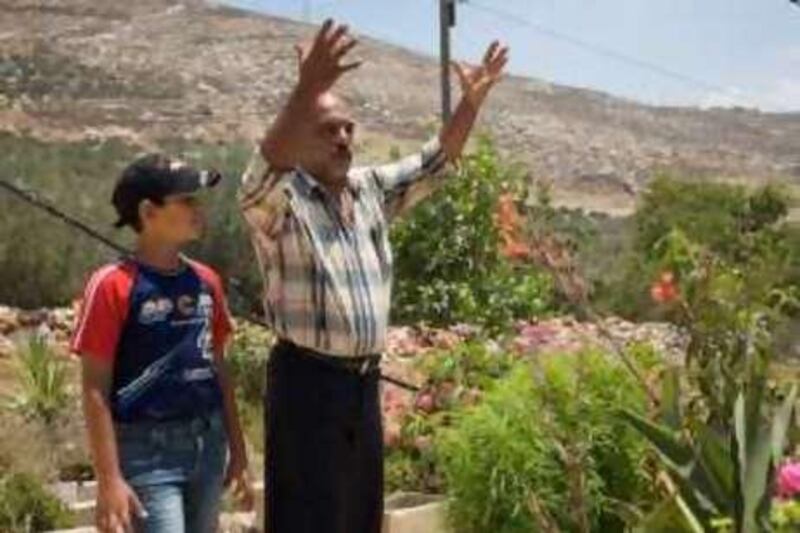 Witness of rocket attack and retired policeman Jamal Najjar, 48, and his son, Ahmad Najjar, 11.

Credit: Alexei Kidel for The National *** Local Caption ***  Burin_Nablus5.jpg