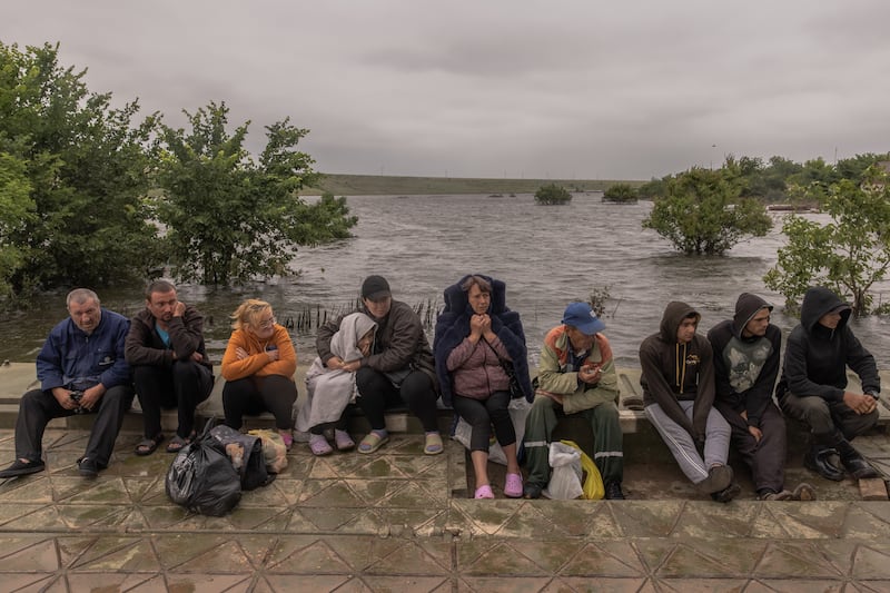 People wait for a transfer on a pontoon in a flooded area as the result of the Kakhovka dam destruction in June 2023 in Afanasiivka village, Mykolaiv region. Getty Images