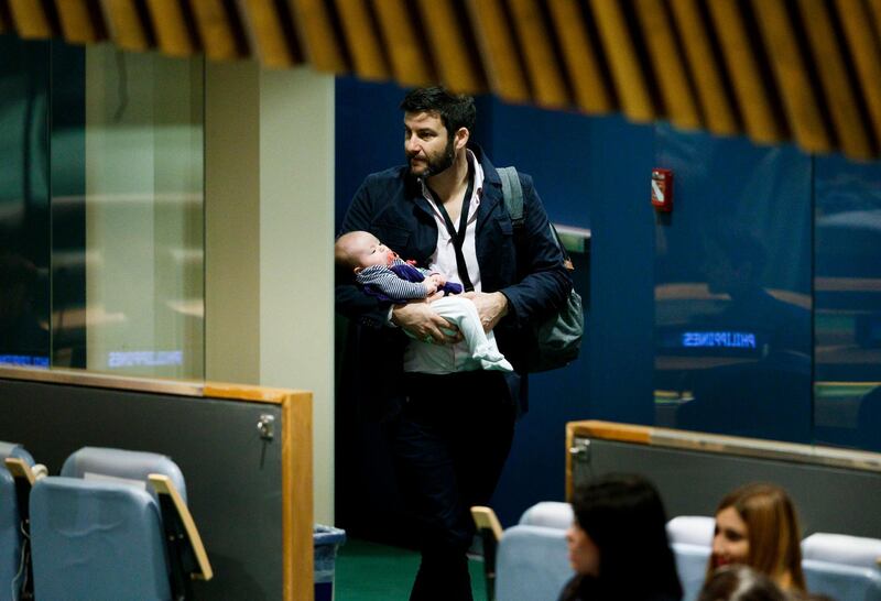 Clarke Gayford, partner of New Zealand Prime Minister Jacinda Ardern, carries their daughter Neve after listening to Ardern speak at the Nelson Mandela Peace Summit during the 73rd session of the General Assembly of the United Nations at United Nations Headquarters.  EPA