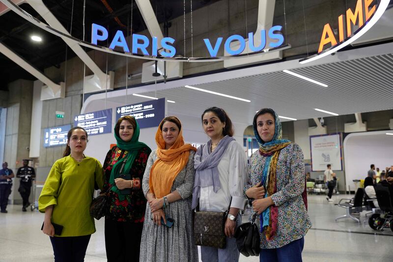 From left, English teacher Hafsa, Najla Latif, president of a science faculty, Naveen Hashim, researcher and women's rights activist, Zakia Abasi, former employee of a beauty salon and TV journalist Muzhgan Feraji arrive at Charles de Gaulle airport in Paris. AFP