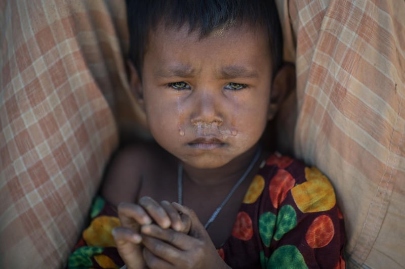 TOPSHOT - A Rohingya Muslim refugee child cries as she sits in the Kutupalong refugee camp in Cox's Bazar on December 4, 2017.
Rohingya are still fleeing into Bangladesh even after an agreement was signed with Myanmar to repatriate hundreds of thousands of the Muslim minority displaced along the border, officials said on November 27.  / AFP PHOTO / Ed JONES