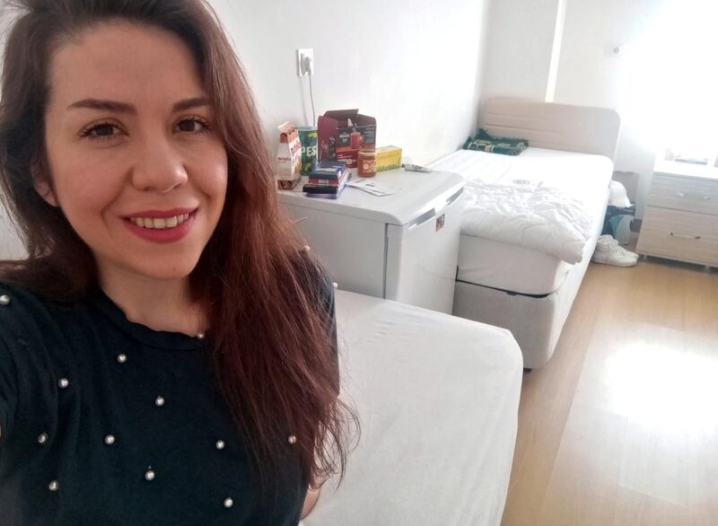 Selin Duygu Yucelen poses for a selfie in her room at a student dormitory where she is under a mandatory 14-day quarantine after returning from abroad, as part of the measures to prevent the spread of the coronavirus in Bingol, Turkey.  Reuters