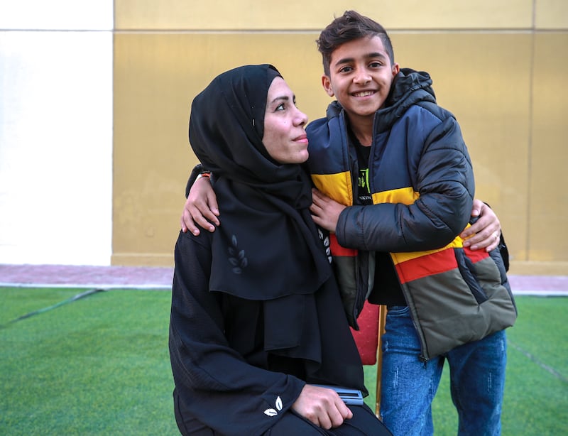 Yazan Abu Hasira, 13, with his mother, Maryam, at Emirates Humanitarian City in Abu Dhabi. All photos: Victor Besa / The National