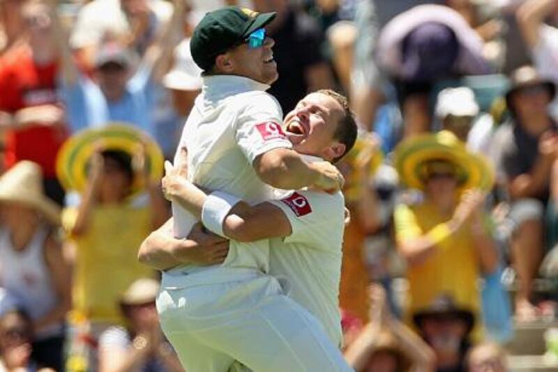 PERTH, AUSTRALIA - JANUARY 15:  David Warner (L) and Peter Siddle of Australia celebrate their victory during day three of the Third Test match between Australia and India at WACA on January 15, 2012 in Perth, Australia.  (Photo by Hamish Blair/Getty Images)