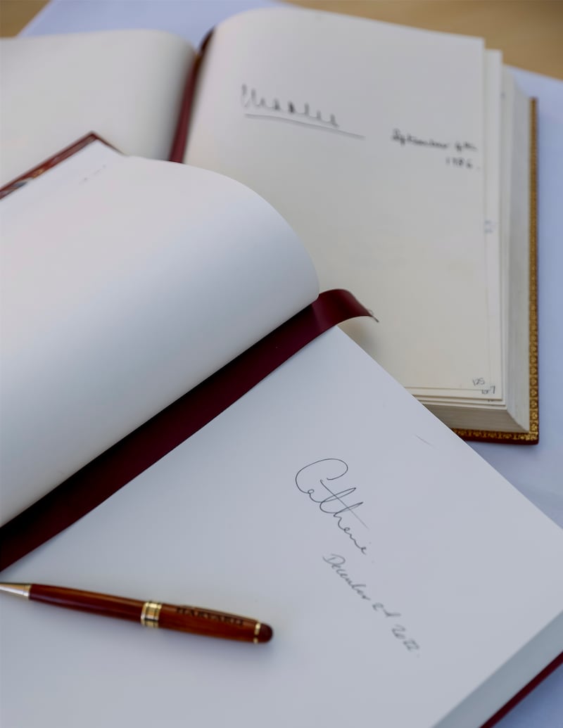 A signature by King Charles III, then Prince of Wales, in a guest book above one signed by Kate. AP