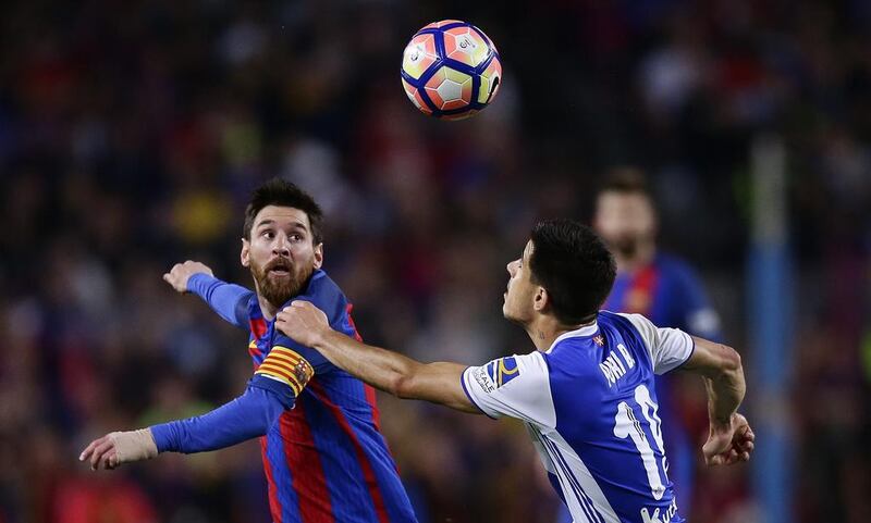 Barcelona’s Lionel Messi, left, duels for the ball against Real Sociedad’s Yuri Berchiche. Manu Fernandez / AP Photo