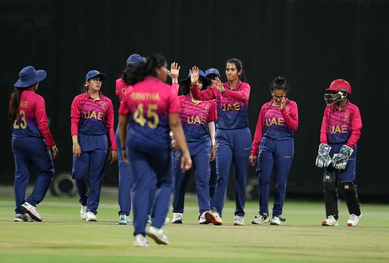 UAE's Khushi Sharma celebrates with teammates after bowling Netherlands captain Heather Siegers for 12
