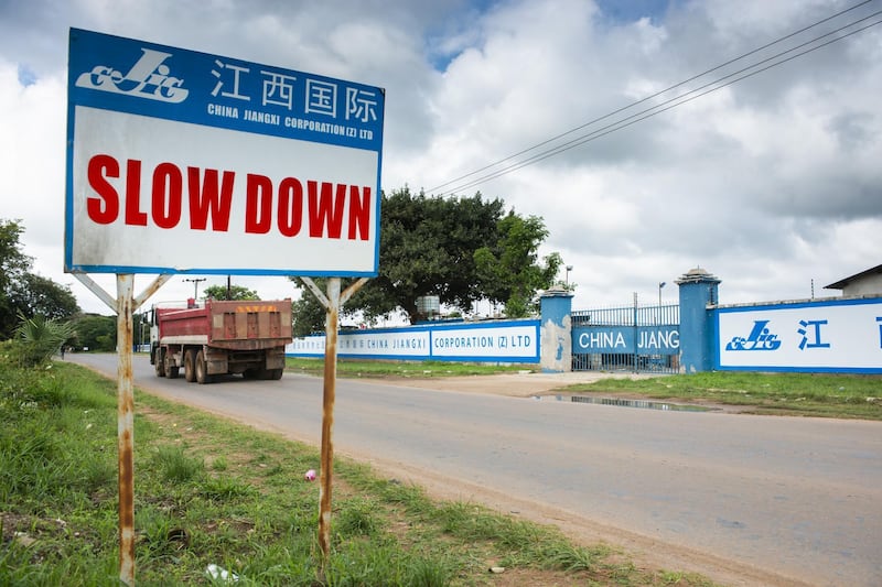A road sign stands outside a China Jiangxi Corporation Ltd. construction site in Lusaka, Zambia, on Wednesday, Dec. 12, 2018. Most of the digital infrastructure projects in Zambia, like the more visible airport terminals and highways, are being built and financed by China, putting the country at what the International Monetary Fund calls a high risk of debt distress. Photographer: Waldo Swiegers/Bloomberg