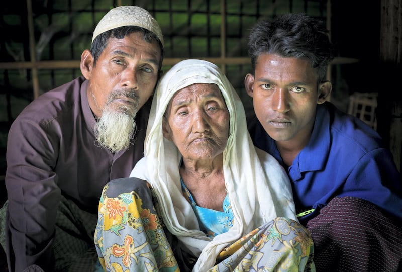 STRICTLY NO USE BEFORE 05:00 GMT (09:00 UAE) 18 JUNE 2020

Oli Ahmed, 53, Gul Zahar, 90, and Mohammad Siddiq, 25, pose for a photo in their shelter.  They are part of a family representing four generations of Rohingya. ; Almost 700,000 Rohingya refugees fled Myanmar, seeking safety in Bangladesh in 2017. While UNHCR intensified efforts to respond to this mass displacement and provide shelter in and around existing camps near Cox’s Bazar, the sheer numbers mean there is much hardship to contend with. Whole families, young widowed mothers and unaccompanied minors were among those fleeing from persecution, rape and violence in northern Rakhine state. Many arrived traumatised, in poor physical condition and in need of life-saving support. Cramped and deprived living conditions in the camps present concerns, but despite the difficulties, the Rohingya feel safe compared to the situation back home. UNHCR is providing protection, food, clean water, shelter, health care, trauma counselling and reunification for separated families.
