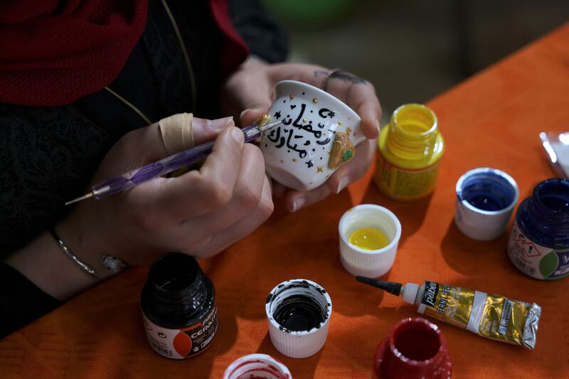 A Palestinian woman makes decorations ahead of the weekend.  AFP