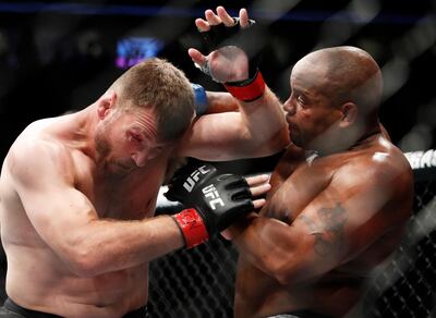 FILE - In this July 7, 2018, file photo, Daniel Cormier, right, fights Stipe Miocic during a heavyweight title mixed martial arts bout at UFC 226 in Las Vegas. The trilogy fight between Daniel Cormier and champ Stipe Miocic will crown the greatest heavyweight of all time. UFC 252 Saturday, Aug. 15, 2020, in Las Vegas could be Cormier's last fight ever. (AP Photo/John Locher, File)