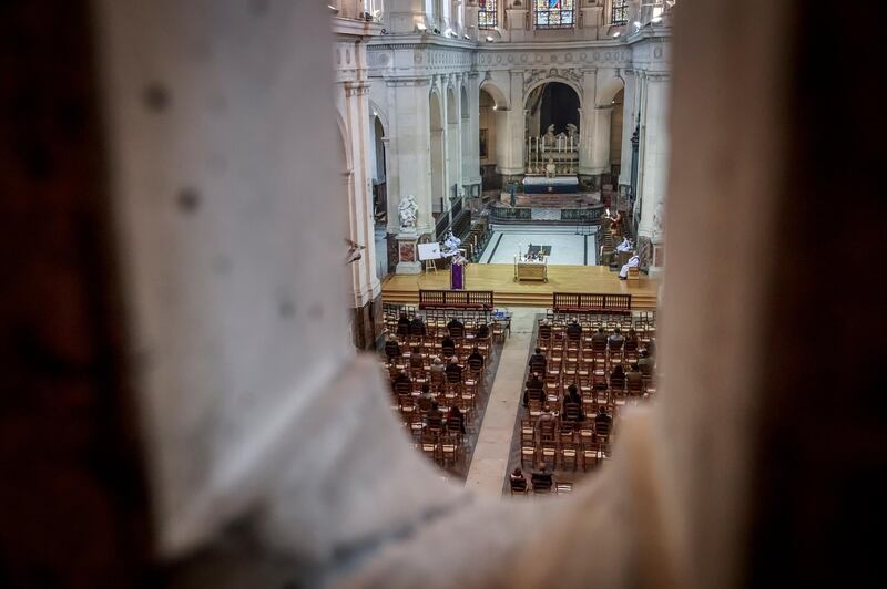 Faithful attend the mass at St Roch Church in Paris, France. Churches have reopened in France with a maximum capacity of 30 people after being closed since October 30, 2020, due to the second wave of the Covid-19 pandemic.  EPA