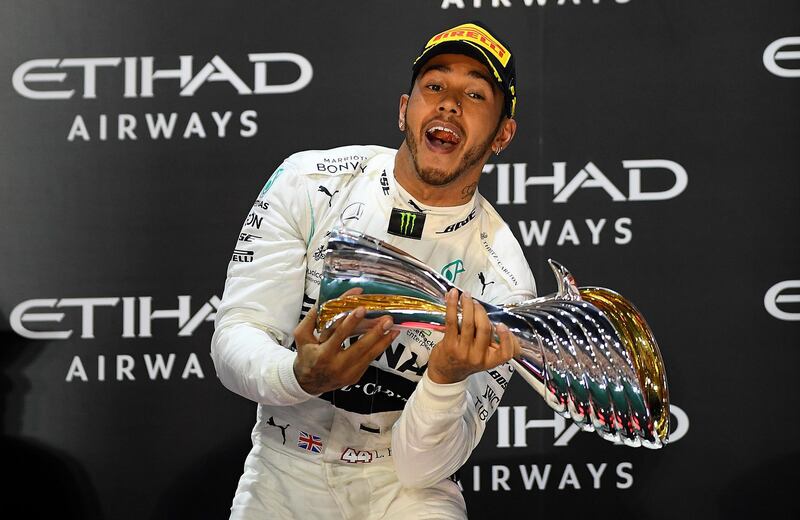 ABU DHABI, UNITED ARAB EMIRATES - DECEMBER 01: Race winner Lewis Hamilton of Great Britain and Mercedes GP celebrates on the podium during the F1 Grand Prix of Abu Dhabi at Yas Marina Circuit on December 01, 2019 in Abu Dhabi, United Arab Emirates. (Photo by Clive Mason/Getty Images)