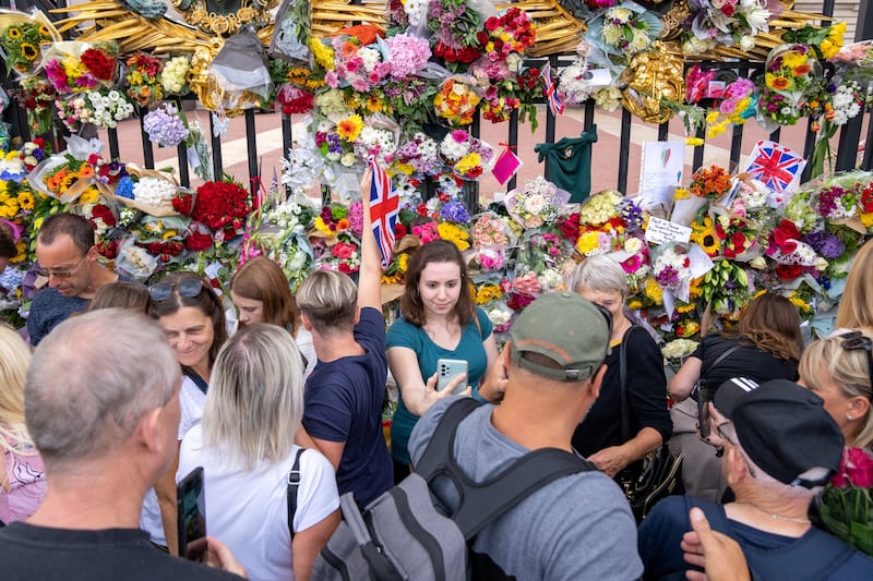 People lay flowers at Buckingham Palace in London. Reuters