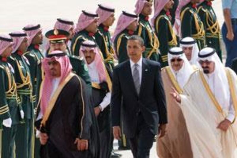 The Saudi King Abdullah bin Abdul Aziz al-Saud (right) escorts the US president Barack Obama (centre) past an honour guard during an arrival ceremony in Riyadh.